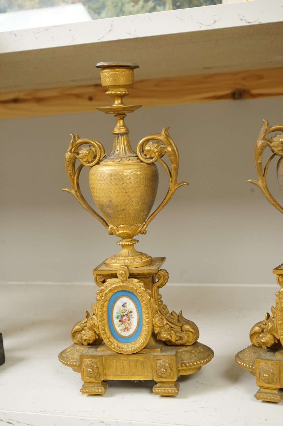 A pair of 19th century gilt metal candlesticks with inset porcelain panels, 32cm high